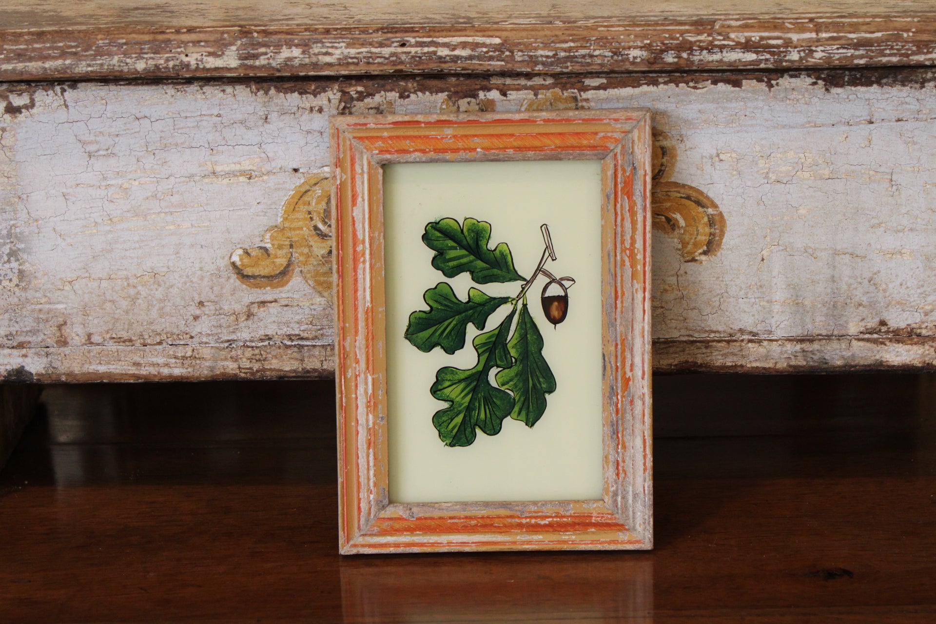Vintage Reverse Glass Acorn with Oak Leaf in an Orange Reeded Frame