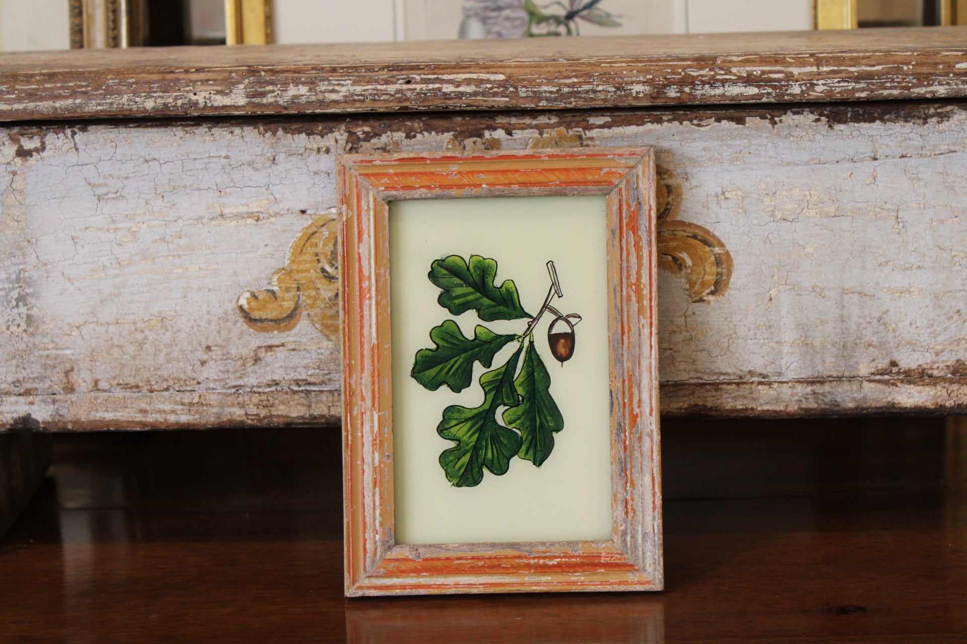 Vintage Reverse Glass Acorn with Oak Leaf in an Orange Reeded Frame