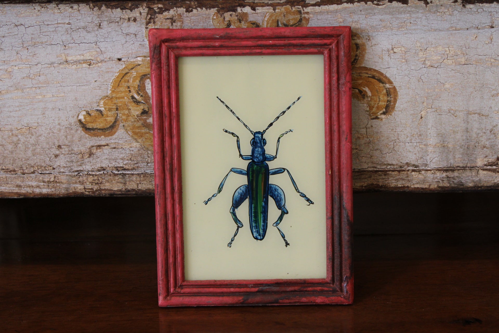 Vintage Reverse Glass Bright Blue Insect in a Pink Reeded Frame
