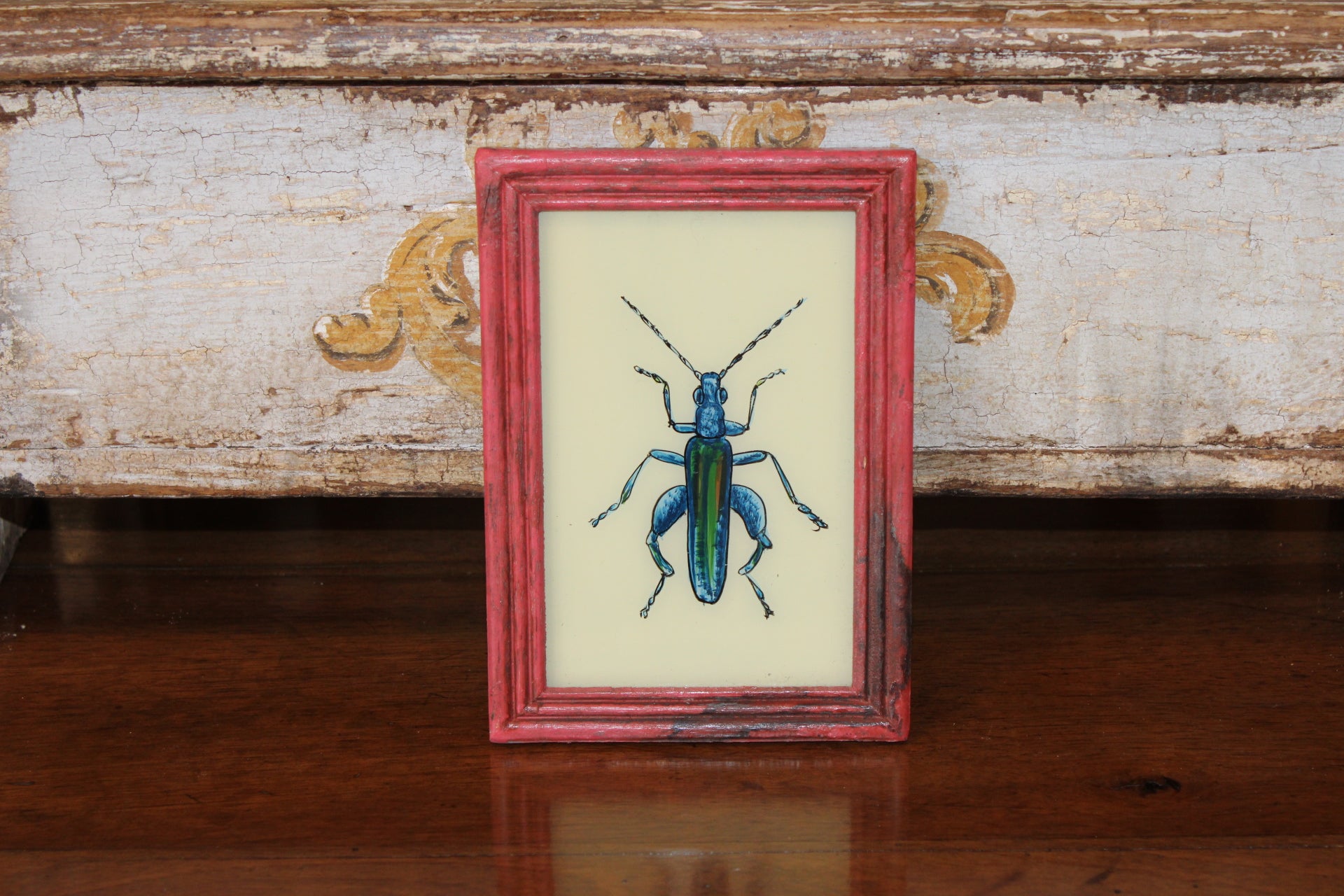Vintage Reverse Glass Bright Blue Insect in a Pink Reeded Frame